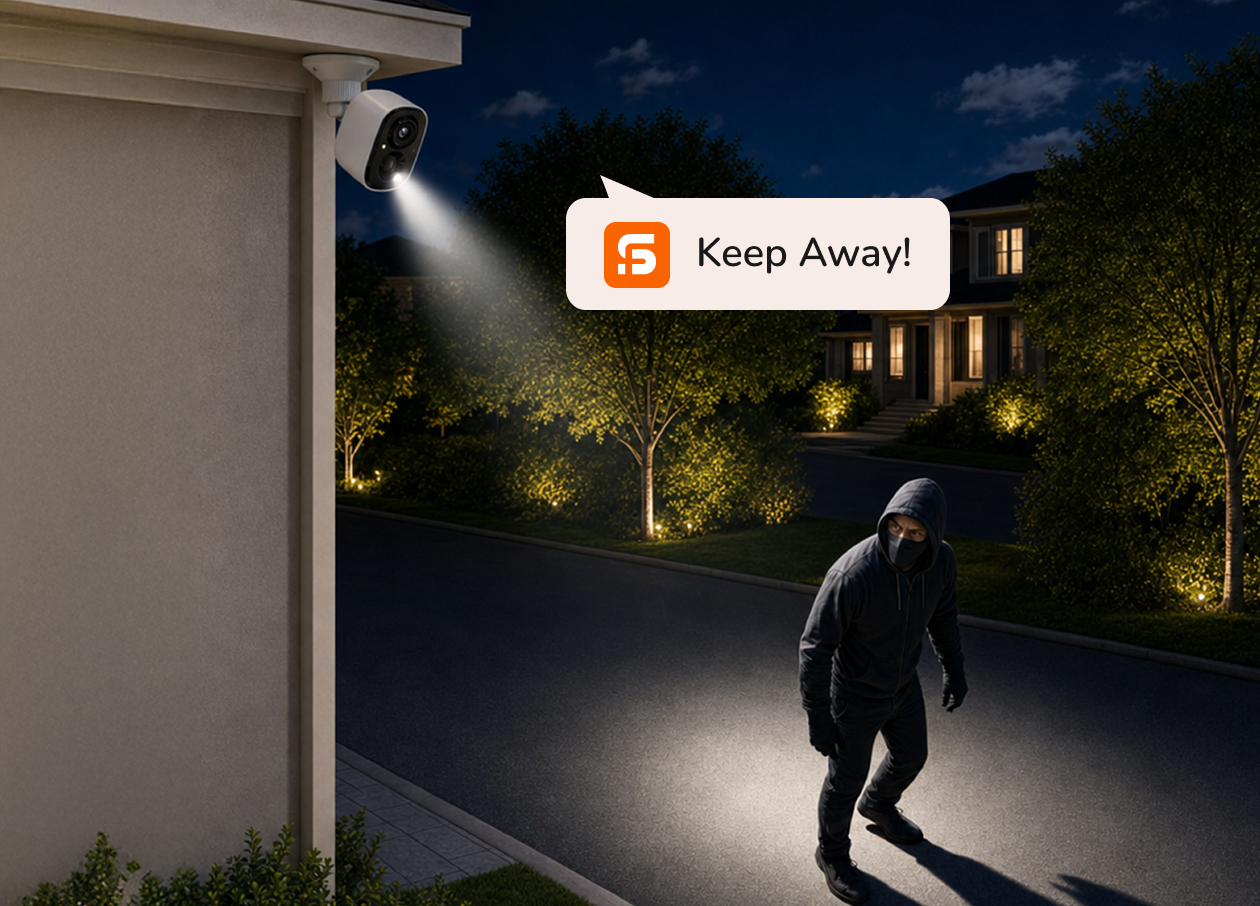 Camera spotlight deterring an intruder at night